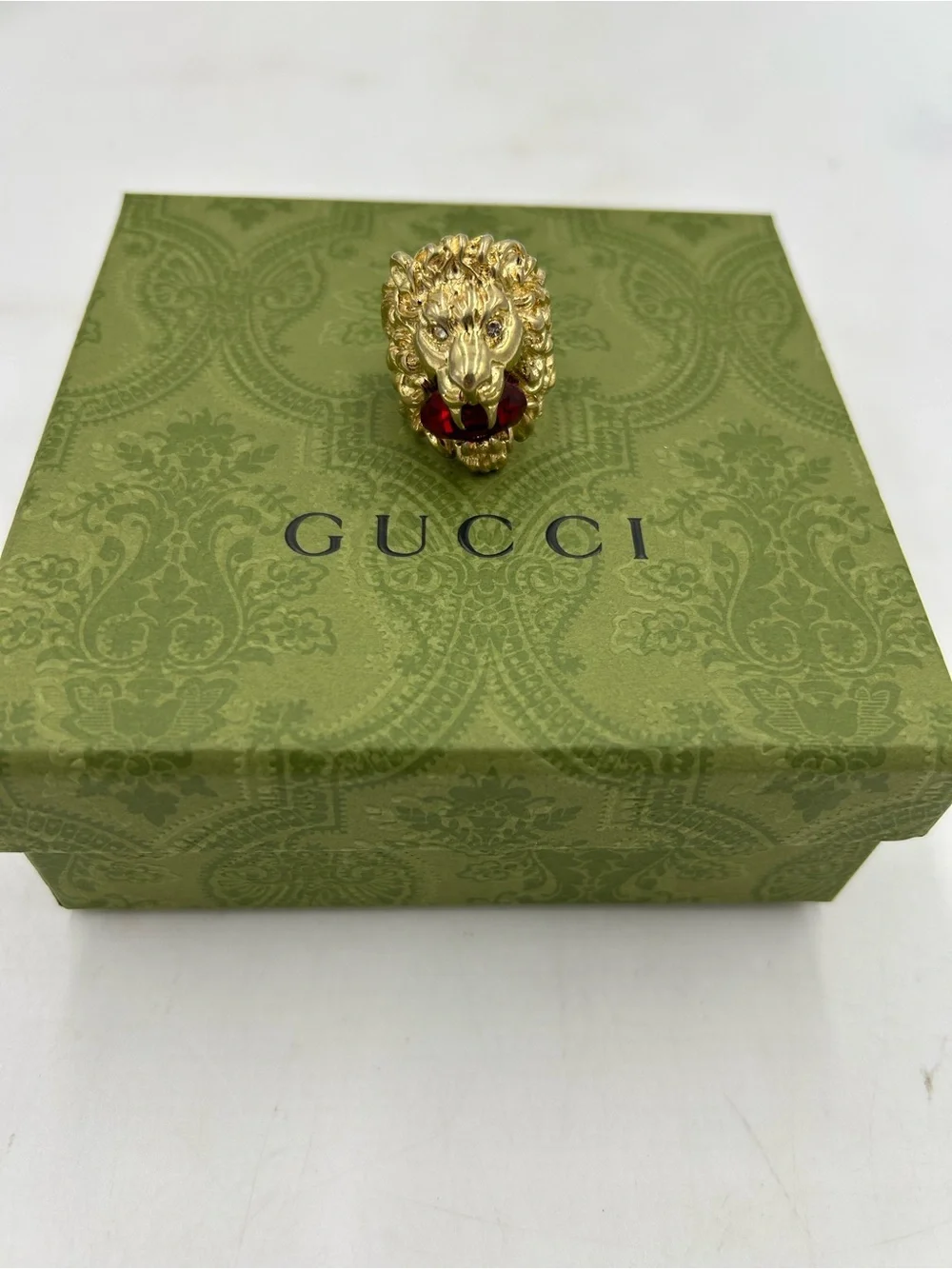 Unisex Gucci, Lionhead motif  gold tone with red crystal size 8.5 made in Italy